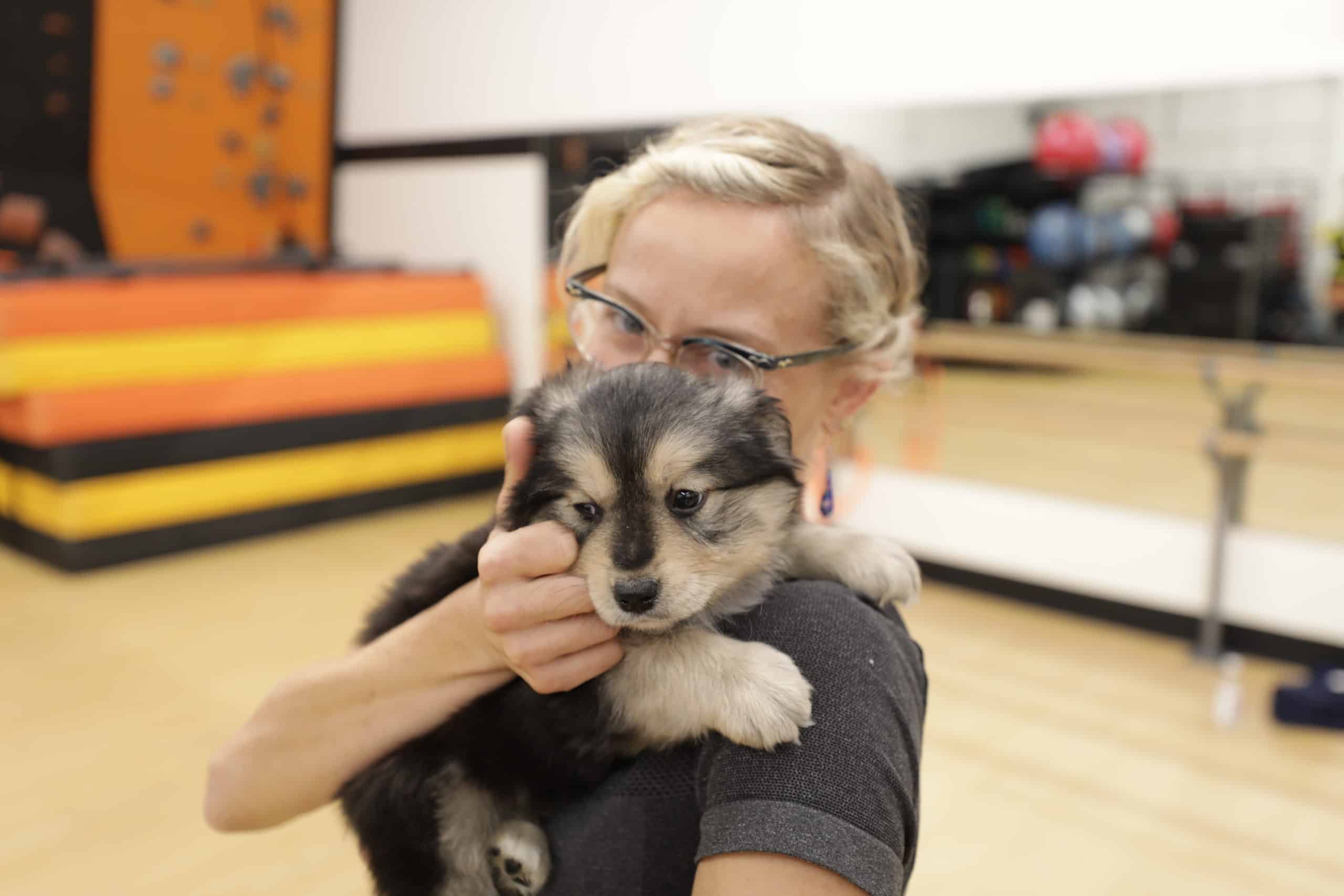 Yoga instructor Jeanine Ten Broeck with puppy at AFAC gym in Thornton, CO