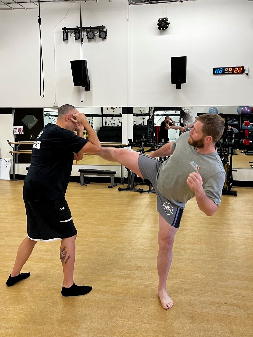 Two men sparring at MMA class at AFAC gym