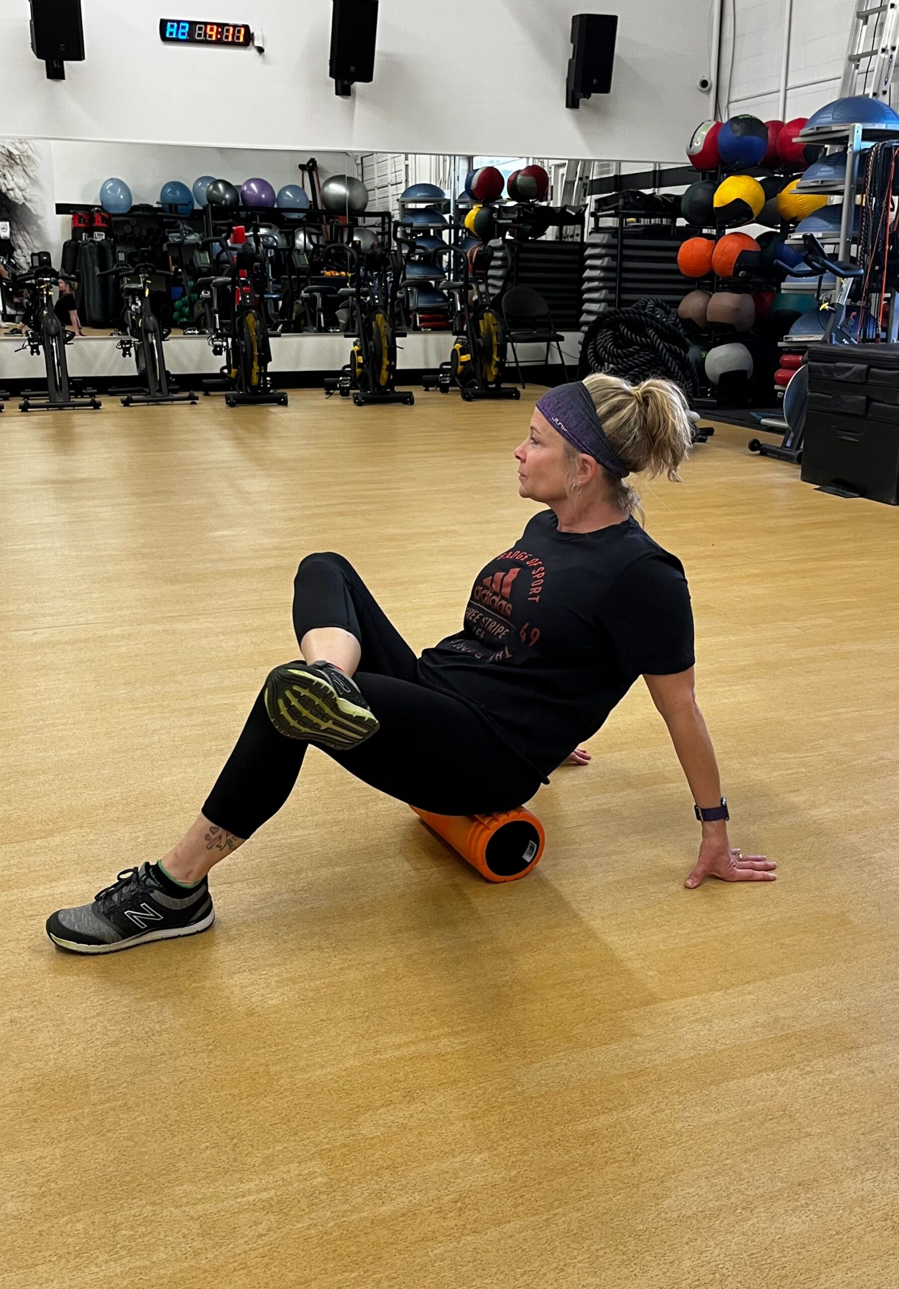 Woman sitting on foam roller at AFAC gym