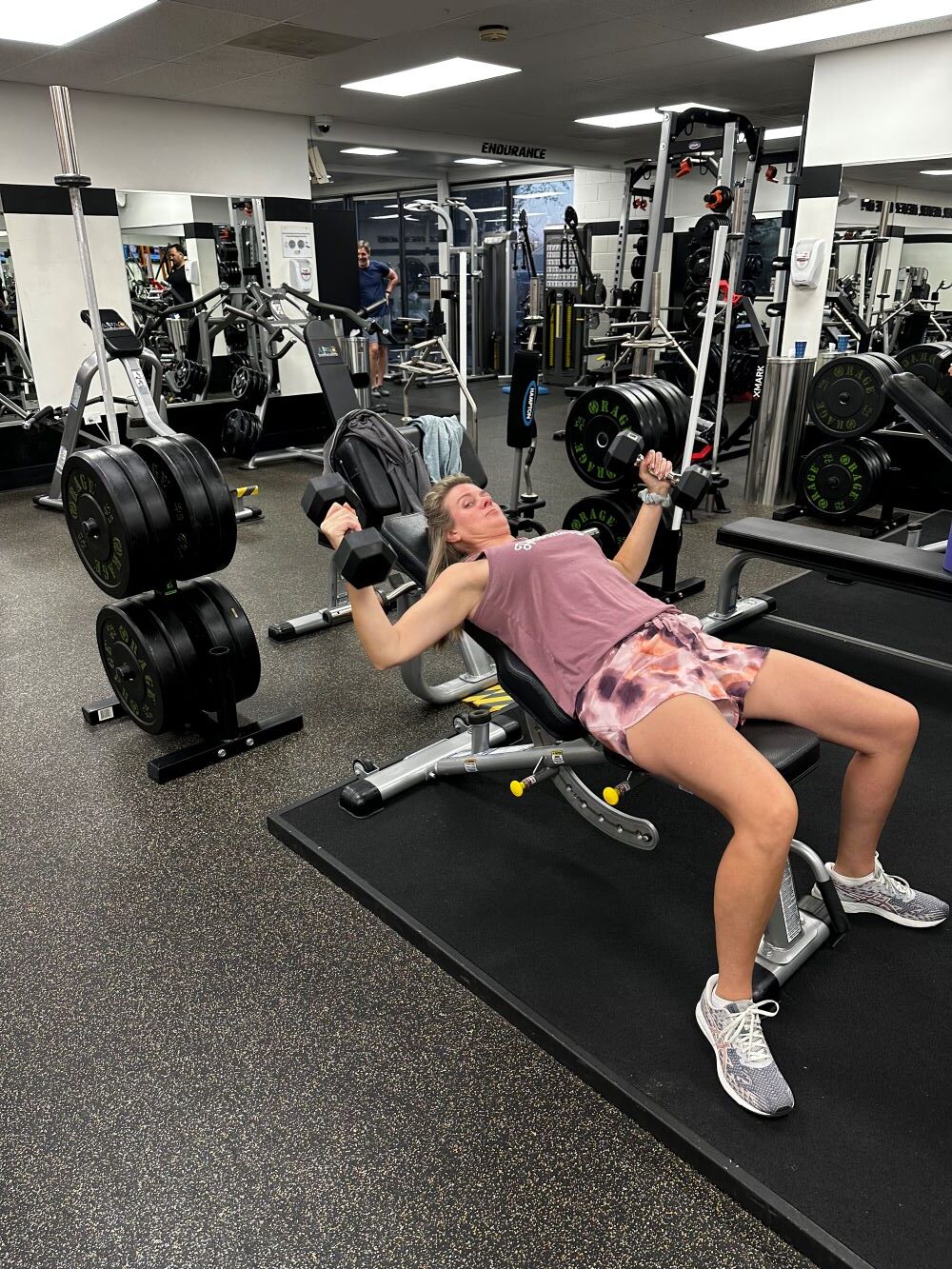 Woman doing dumbbell chest fly at AFAC Gym