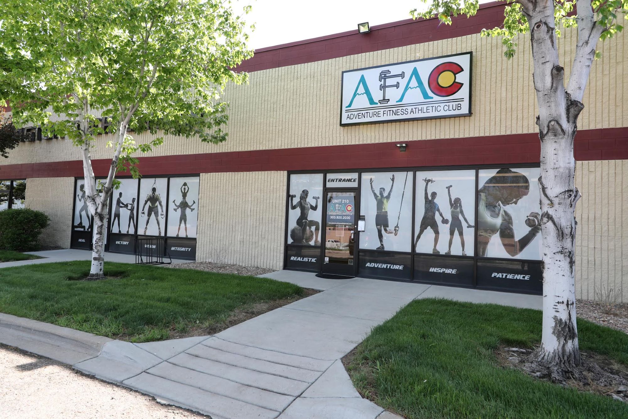 Front view of AFAC gym in Thornton, CO, on a warm spring day