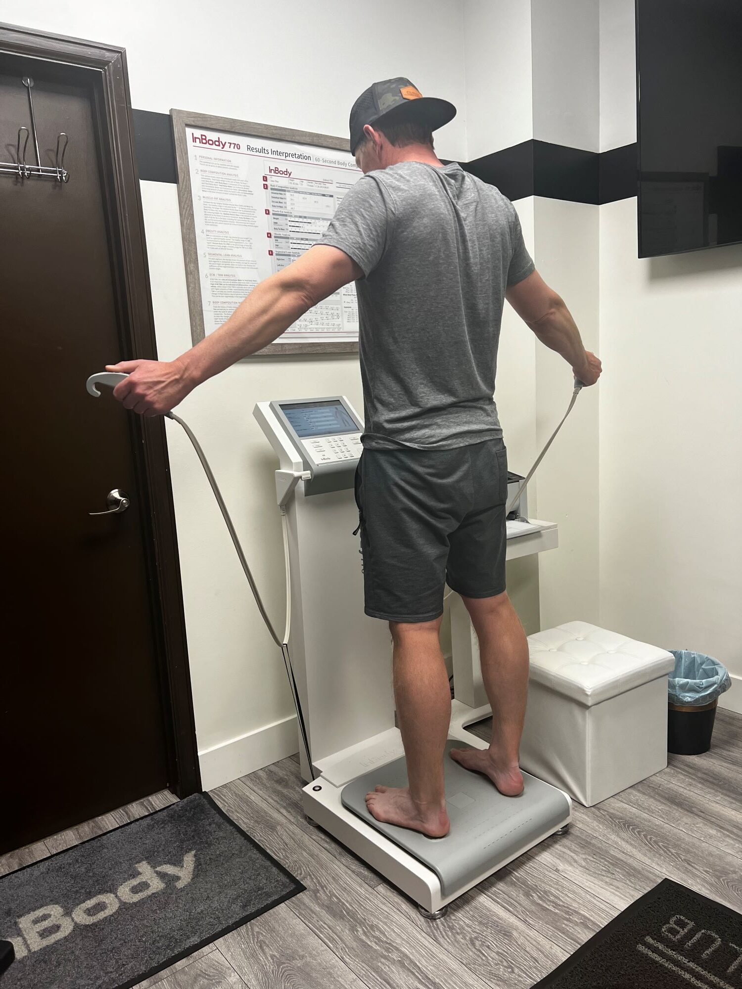 Man standing on InBody 770 body composition machine and holding handles at AFAC gym