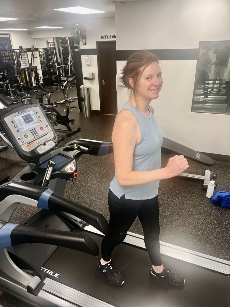Woman walking backward on a treadmill at AFAC gym