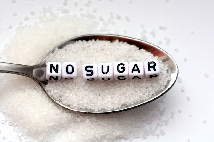 Spoonful of sugar with white square beads that spell out "no sugar"