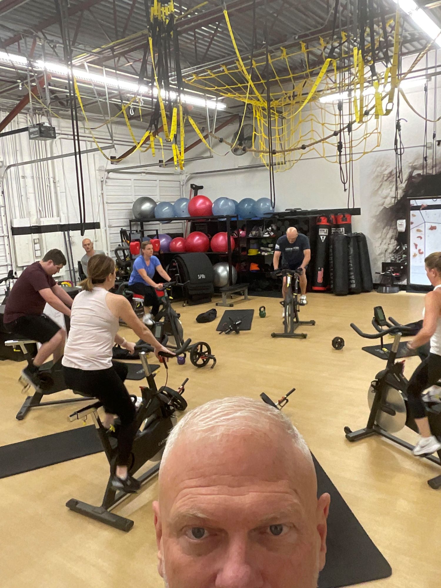 Photo of a boot camp class at AFAC gym with several participants on spin bikes