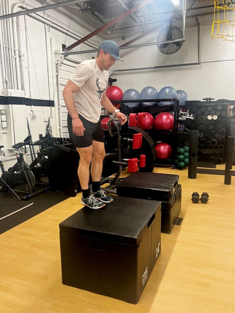 Man stands on top of black box at AFAC gym