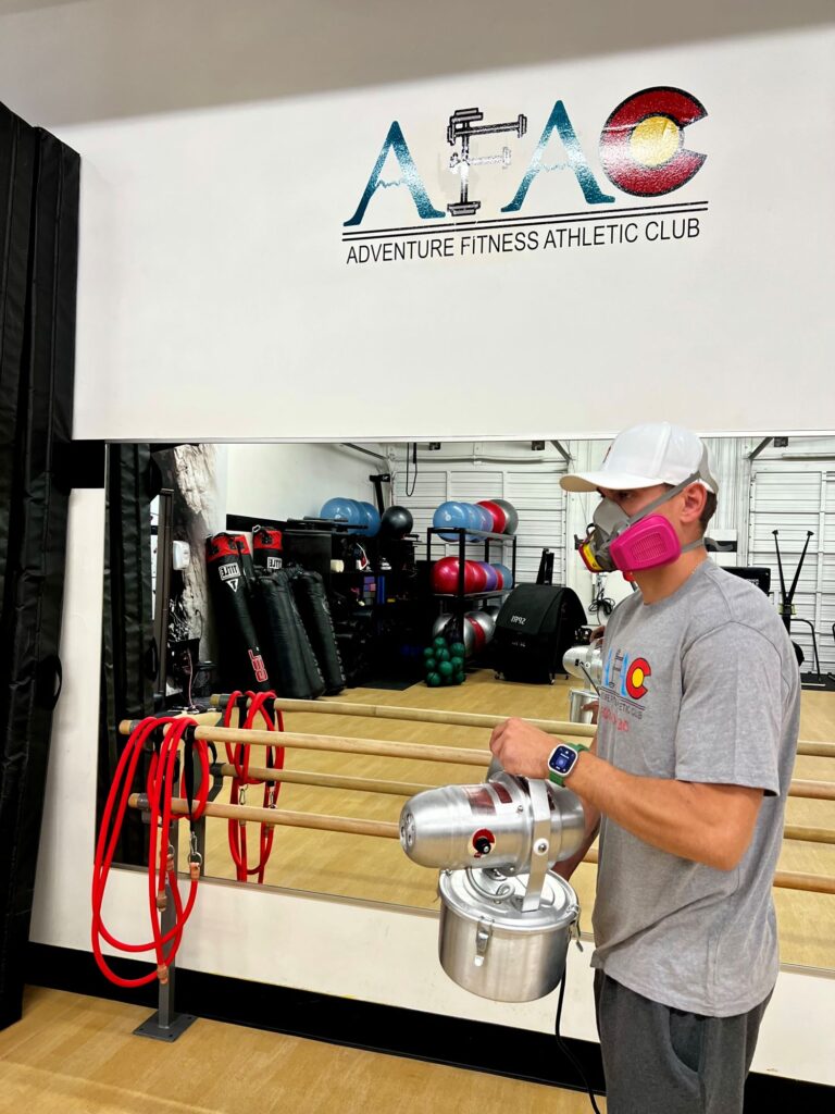 Worker at AFAC gym sanitizes the facility with hospital-grade fogging disinfectant