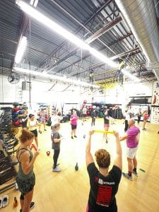 Several gym members participate in a group class at AFAC gym.