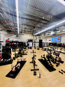 Group of people laying down and exercising on yoga mats at AFAC gym