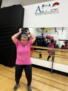 Susan Schaffner, owner of AFAC gym, performs the kettlebell halo exercise.