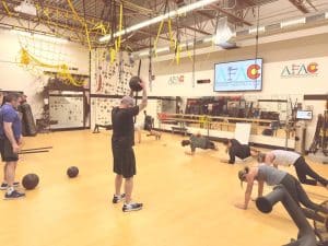Group of gym members work out during a class at AFAC gym.