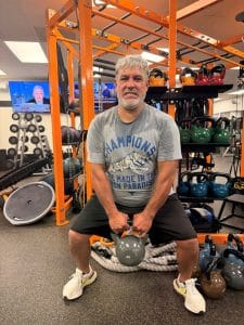 Man doing a sumo squat with a kettlebell at AFAC gym