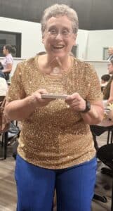 Susan Schaffner, owner of AFAC gym, smiles as she holds the 2026 People's Choice Award