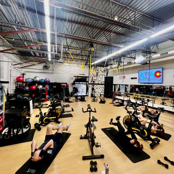 Group of people laying down and exercising on yoga mats at AFAC gym